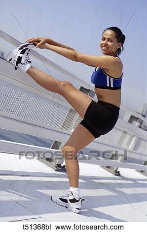 Woman stretching outdoors View Large Photo Image Stock Image - Woman stretching outdoors. Fotosearch
