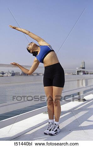 Woman stretching outdoors View Large Photo Image Stock Image - Woman stretching outdoors. Fotosearch