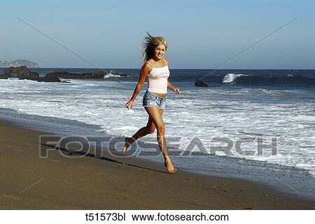 Woman strolling on seashore View Large Photo Image Stock Image - Woman strolling on seashore. Fotosearch