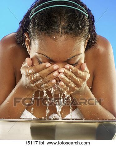 Woman washing her face View Large Photo Image Stock Image - Woman washing her face. Fotosearch