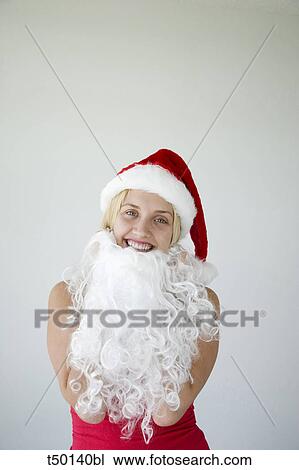 Woman wearing Santa Claus hat and beard View Large Photo Image Stock Image - Woman wearing Santa Claus hat and beard. Fotosearch
