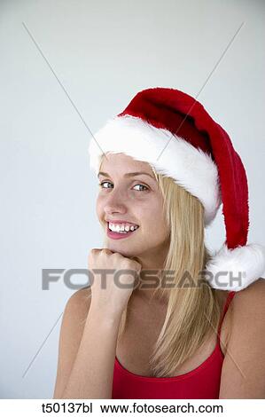 Woman wearing Santa Claus hat View Large Photo Image Stock Image - Woman wearing Santa Claus hat. Fotosearch