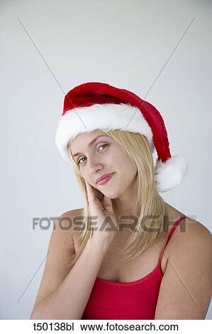 Woman wearing Santa Claus hat View Large Photo Image Stock Image - Woman wearing Santa Claus hat. Fotosearch