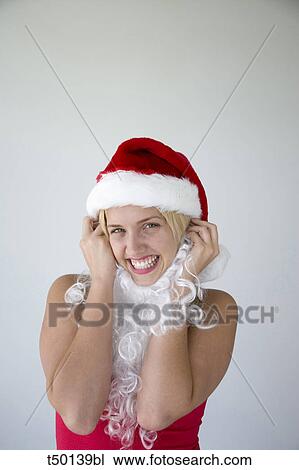 Woman wearing Santa Claus hat View Large Photo Image Stock Image - Woman wearing Santa Claus hat. Fotosearch