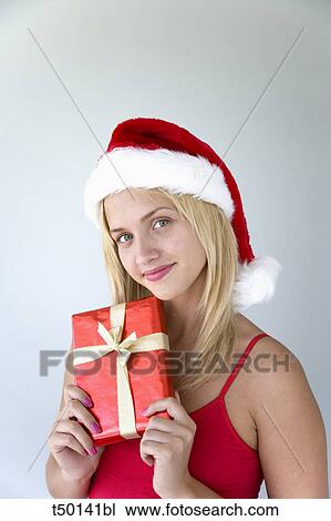 Woman wearing Santa Claus hat with gift View Large Photo Image Stock Image - Woman wearing Santa Claus hat with gift. Fotosearch