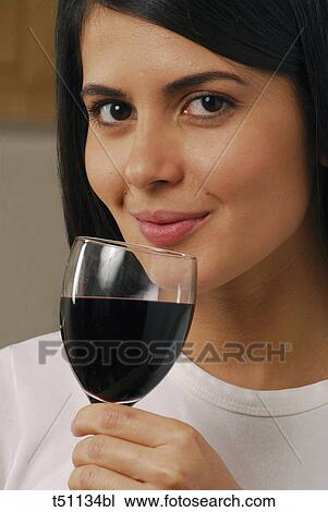 Woman with a glass of red wine View Large Photo Image Stock Image - Woman with a glass of red wine. Fotosearch