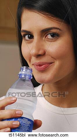Woman with bottle of water View Large Photo Image Stock Image - Woman with bottle of water. Fotosearch