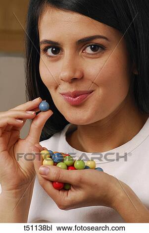 Stock Image - Woman with candies. Fotosearch