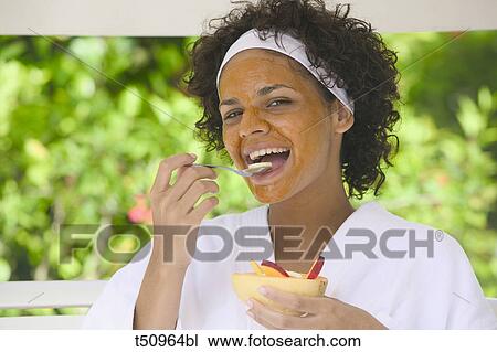 Woman with face mask eating fruits View Large Photo Image Stock Image - Woman with face mask eating fruits. Fotosearch