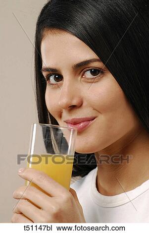 Woman with glass of orange juice View Large Photo Image Stock Image - Woman with glass of orange juice. Fotosearch
