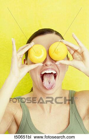 Woman with lemons over her eyes View Large Photo Image Stock Image - Woman with lemons over her eyes. Fotosearch