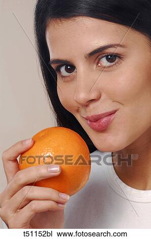 Woman with orange View Large Photo Image Stock Image - Woman with orange. Fotosearch