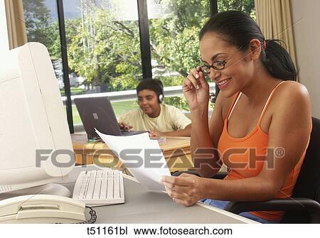 Woman working at home View Large Photo Image Stock Image - Woman working at home. Fotosearch