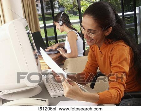 Stock Image - Woman working at home. Fotosearch