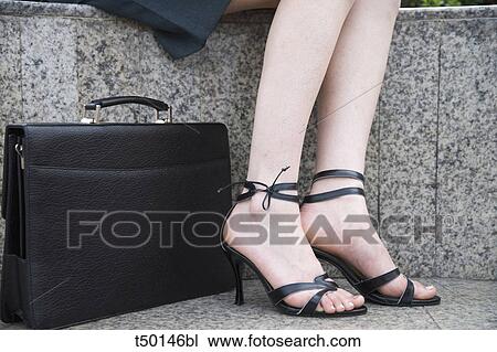 Woman's legs and briefcase View Large Photo Image Stock Image - Woman's legs and briefcase. Fotosearch