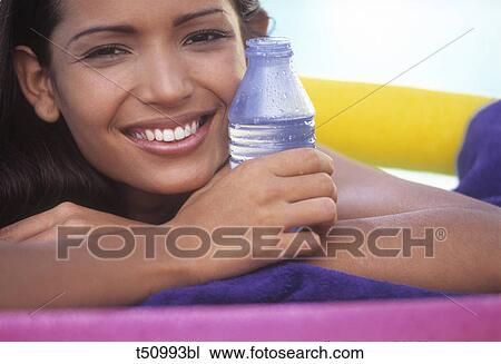 Woman's portrait with bottle of mineral water View Large Photo Image Stock Image - Woman's portrait with bottle of mineral water. Fotosearch