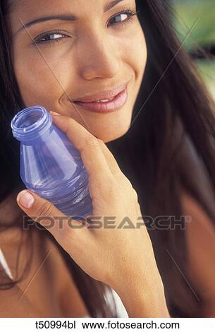 Woman's portrait with bottle of mineral water View Large Photo Image Stock Image - Woman's portrait with bottle of mineral water. Fotosearch