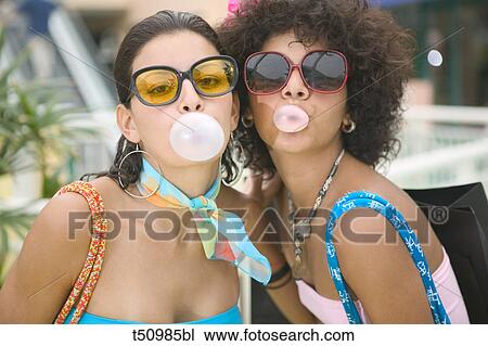 Women blowing bubble gum View Large Photo Image Stock Image - Women blowing bubble gum. Fotosearch