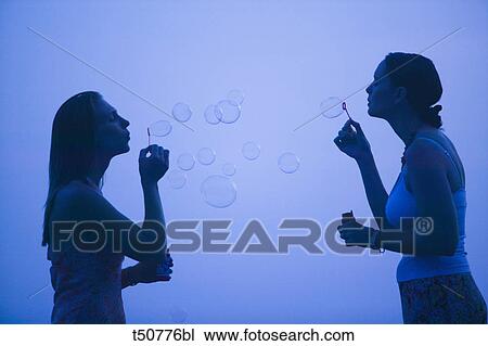 Women blowing bubbles View Large Photo Image Stock Image - Women blowing bubbles. Fotosearch
