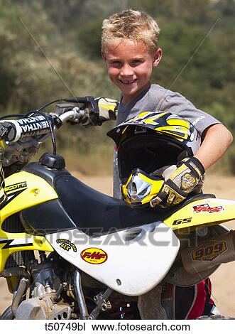 Young boy with motorbike View Large Photo Image Stock Image - Young boy with motorbike. Fotosearch