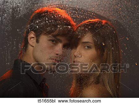 Young couple's portrait behind a wet window View Large Photo Image Stock Image - Young couple's portrait behind a wet window. Fotosearch