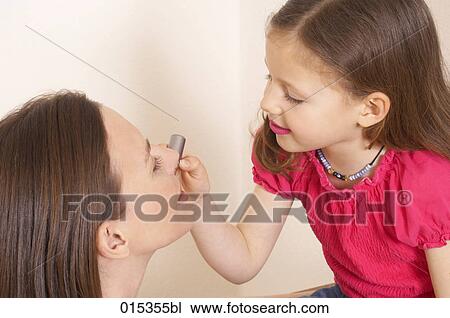 young girl applying some lipstick on her mother´s mouth View Large Photo Image Stock Image - young girl applying some lipstick on her mother´s mouth. Fotosearch