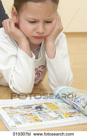 young girl lying on floor reading textbook View Large Photo Image Stock Image - young girl lying on floor reading textbook. Fotosearch
