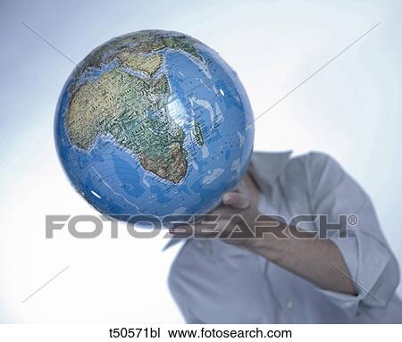 Young man holding a globe View Large Photo Image Stock Image - Young man holding a globe. Fotosearch
