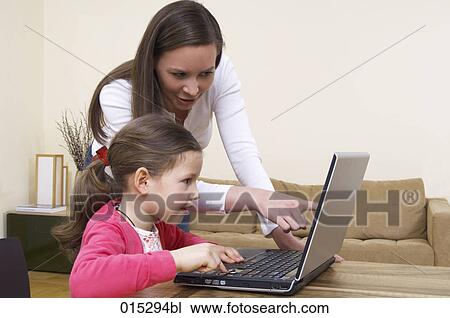 young mother showing little daughter how to work with laptop computer View Large Photo Image Stock Image - young mother showing little daughter how to work with laptop computer. Fotosearch