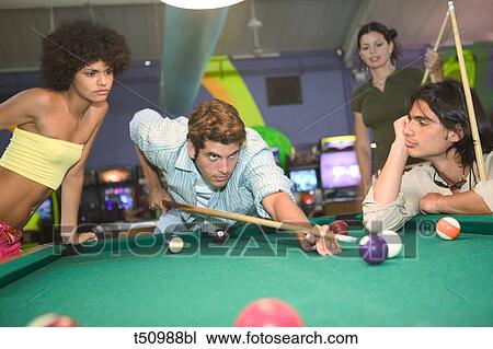 Young people playing billiard View Large Photo Image Stock Image - Young people playing billiard. Fotosearch