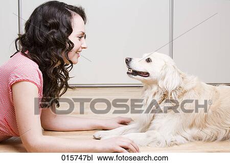 young woman and dog lying on floor looking at each other View Large Photo Image Stock Image - young woman and dog lying on floor looking at each other. Fotosearch