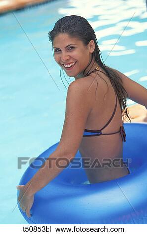 Stock Image - Young woman in swimming pool. Fotosearch