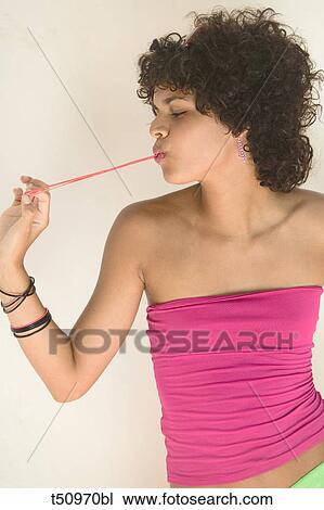Young woman playing with chewing gum View Large Photo Image Stock Image - Young woman playing with chewing gum. Fotosearch