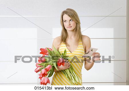 young woman with bunch of tulips and love letter looking disappointed View Large Photo Image Stock Image - young woman with bunch of tulips and love letter looking disappointed. Fotosearch