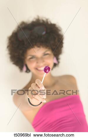 Young woman with lollipop View Large Photo Image Stock Image - Young woman with lollipop. Fotosearch