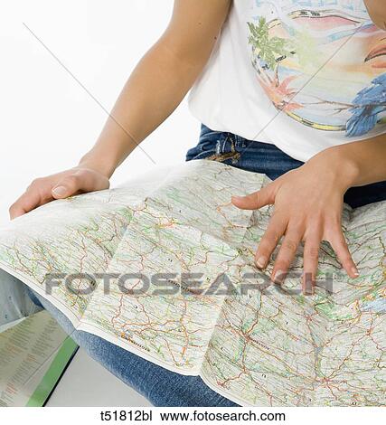 A young woman looking for a map View Large Photo Image Stock Image - A young woman looking for a map . Fotosearch