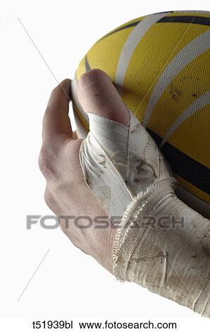 Close up of a rugby player hand holding ball View Large Photo Image Stock Image - Close up of a rugby player hand holding ball . Fotosearch