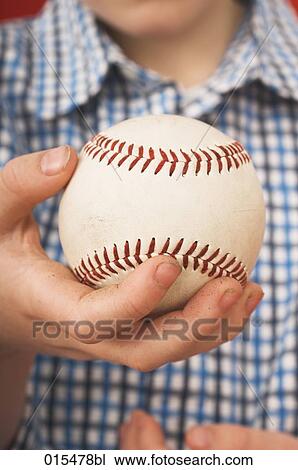 Stock Image - close-up of little boy holding baseball. Fotosearch