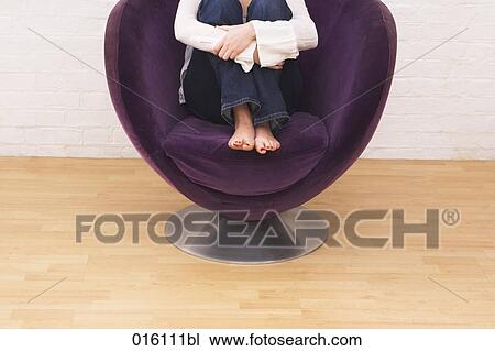 detail of young woman sitting in arm chair View Large Photo Image Stock Image - detail of young woman sitting in arm chair. Fotosearch