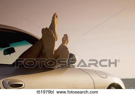 Feet sticking out of a car window View Large Photo Image Stock Image - Feet sticking out of a car window . Fotosearch