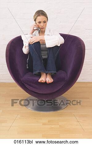 full body portrait of young woman sitting in arm chair talking on mobile phone View Large Photo Image Stock Image - full body portrait of young woman sitting in arm chair talking on mobile phone. Fotosearch