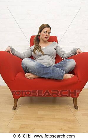 full body portrait of young woman sitting in red arm chair View Large Photo Image Stock Image - full body portrait of young woman sitting in red arm chair. Fotosearch