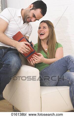 happy young couple at home with present View Large Photo Image Stock Image - happy young couple at home with present. Fotosearch