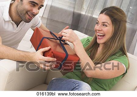 happy young couple at home with present View Large Photo Image Stock Image - happy young couple at home with present. Fotosearch