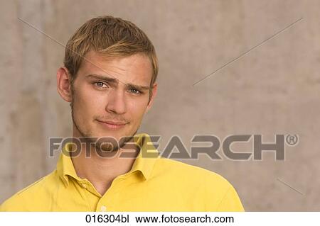 Stock Image - headshot of doubtful looking young man. Fotosearch