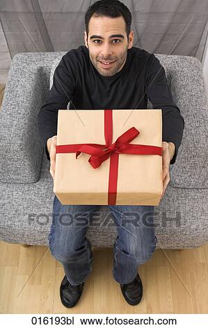 high angle portrait of young man with present View Large Photo Image Stock Image - high angle portrait of young man with present. Fotosearch