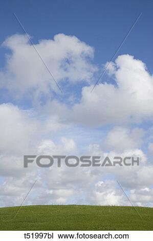 Stock Image - Hill and clouds . Fotosearch
