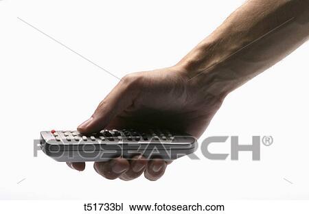 Stock Image - Holding remote control . Fotosearch