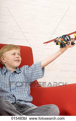 joyous young boy playing with toy airplane View Large Photo Image Stock Image - joyous young boy playing with toy airplane. Fotosearch