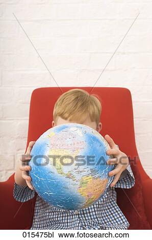 little boy holding globe made of jigsaw pieces View Large Photo Image Stock Image - little boy holding globe made of jigsaw pieces. Fotosearch